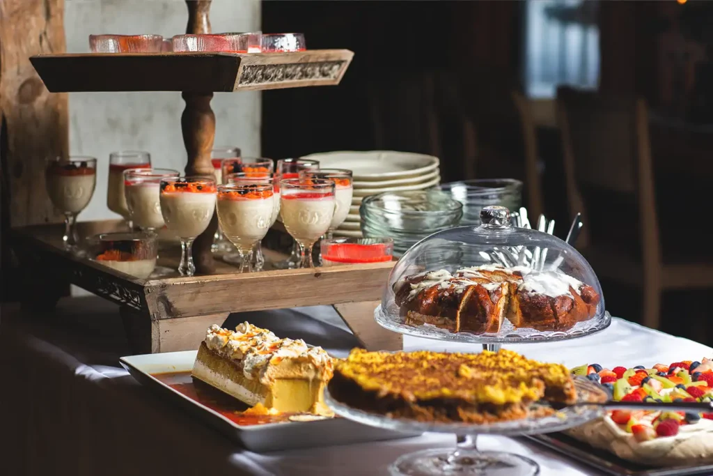 A buffet of desserts and drinks on a storstuu table.